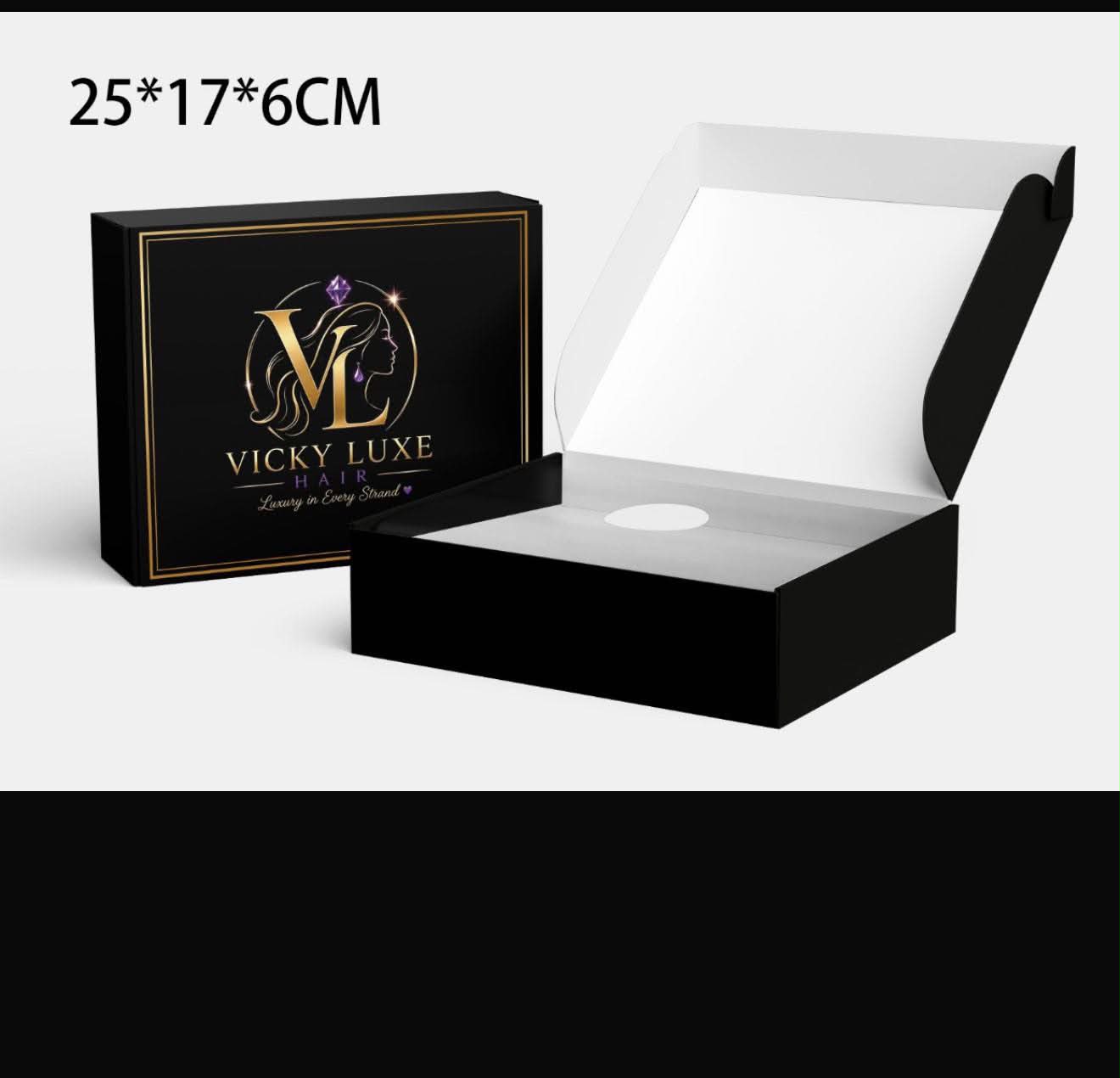 Open and closed Vicky Luxe Hair matte black presentation boxes with gold foil VL logo and border